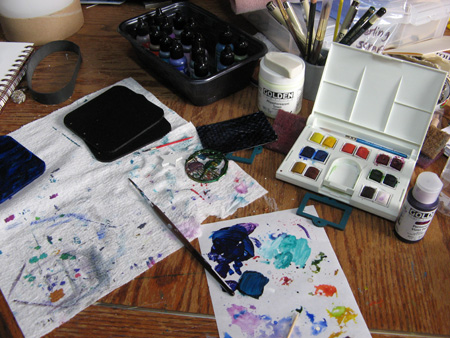 Messy desk with painted items
