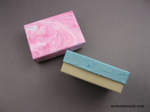 Side of pink and aqua painted boxes