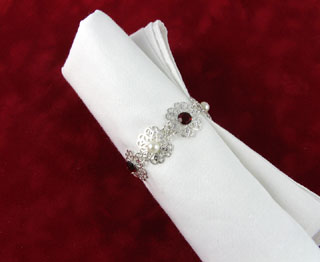 Silver filigree napkin ring with crystal and pearl accents