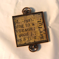 One of Michelle Mach's resin pendants with a dictionary image.